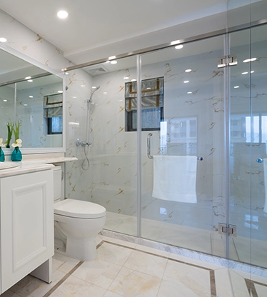 Modern minimalist kitchen with white cabinets, orange backsplash, marble floors, hallway, wooden doors, and a glass display cabinet with gold accents and lighting.